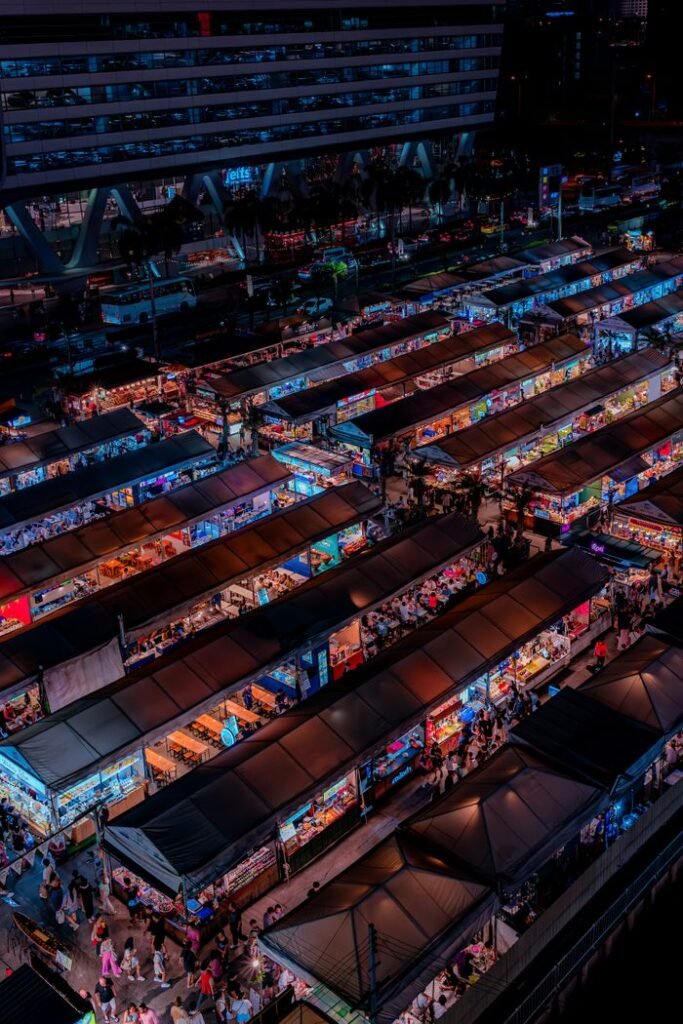 Explore the bustling night market in Bangkok, Thailand, from above.